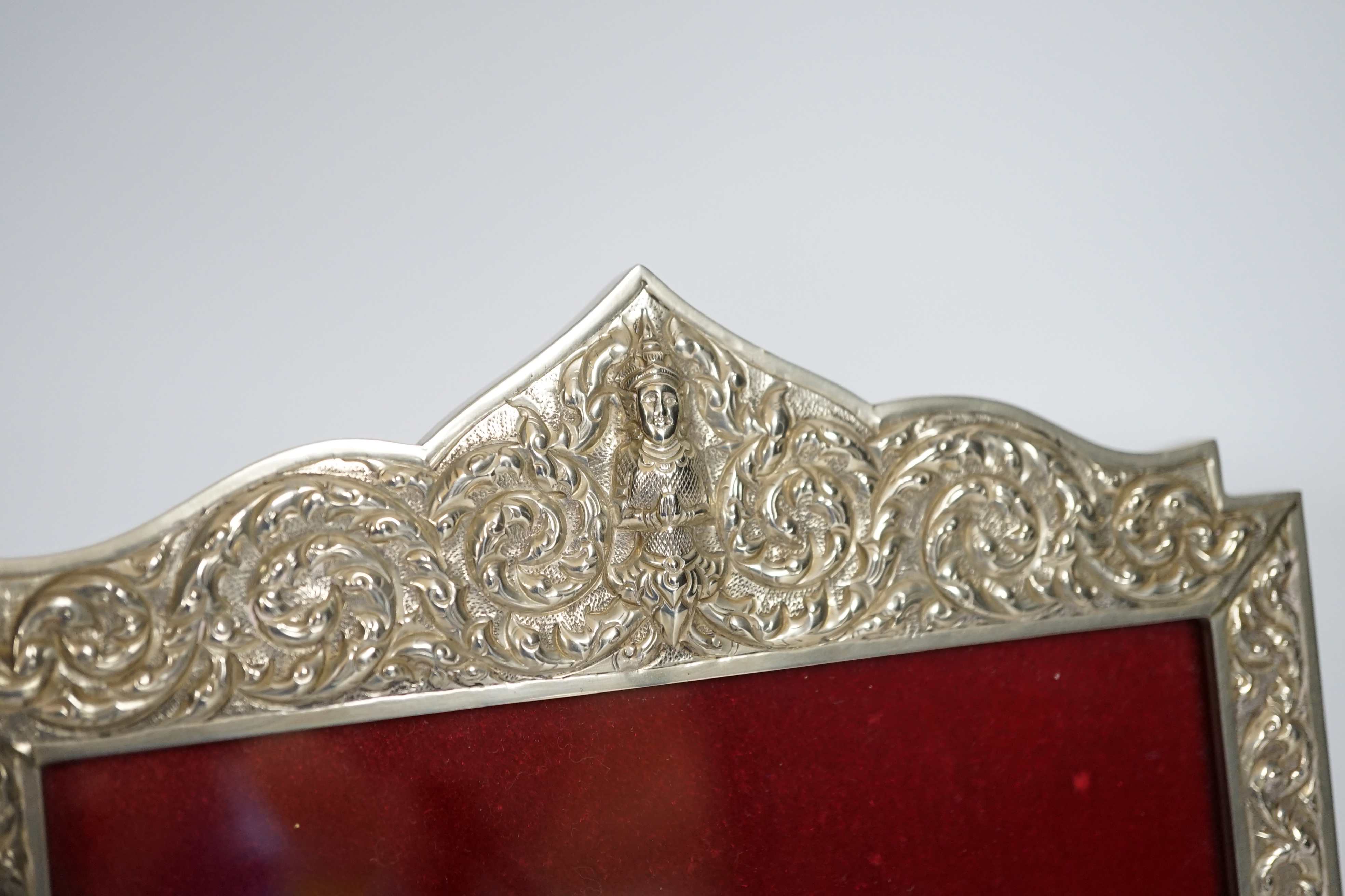 A Thai white metal cigarette box, stamped sterling, 14cm, and a similar sterling overlaid photograph frame, width 16cm